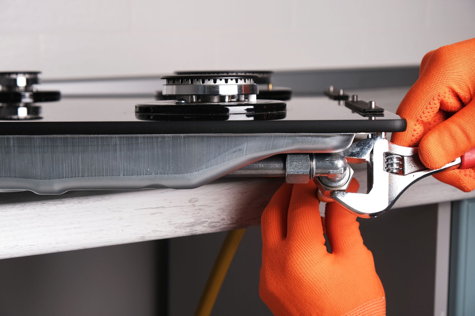 Connecting  Gas Hose To  Hob, Hands With An Adjustable Wrench Cl